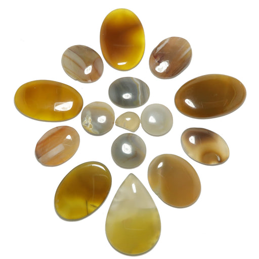 Collection of brown and beige stone beads on a white background