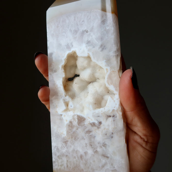 Hand holding a textured Agate with Druzy Quartz crystal