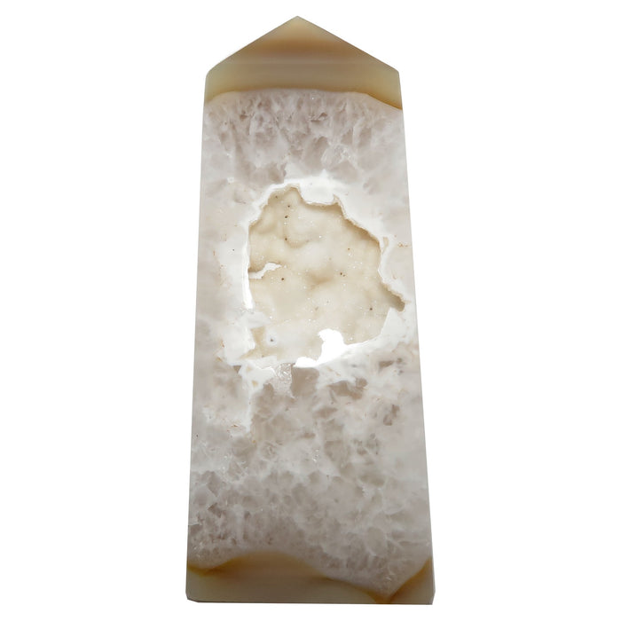 Decorative Agate stone obelisk with a central cavity on a white background