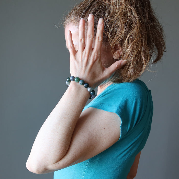 woman wearing moss agate bracelet