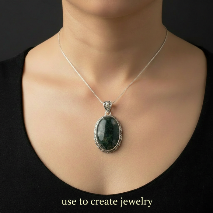 Necklace with a green moss agate pendant on a person against a black background