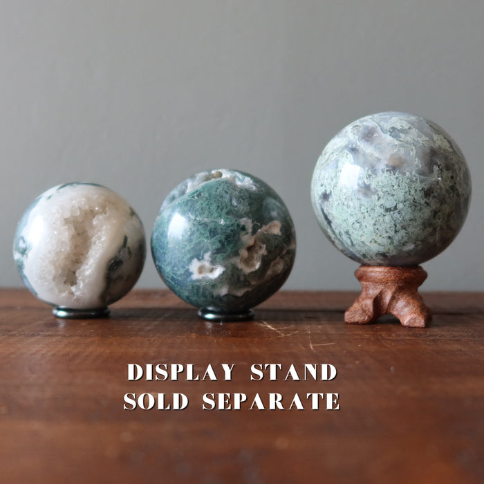 moss agate spheres on display stands