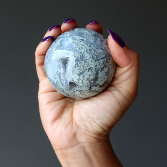 moss agate sphere in hand