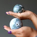 moss agate spheres in hands