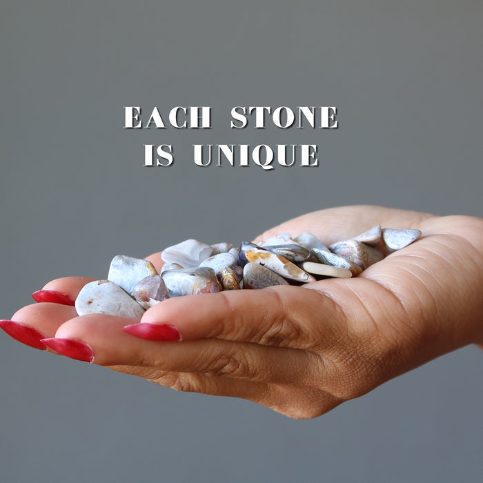 lace agate tumbled stones in hand