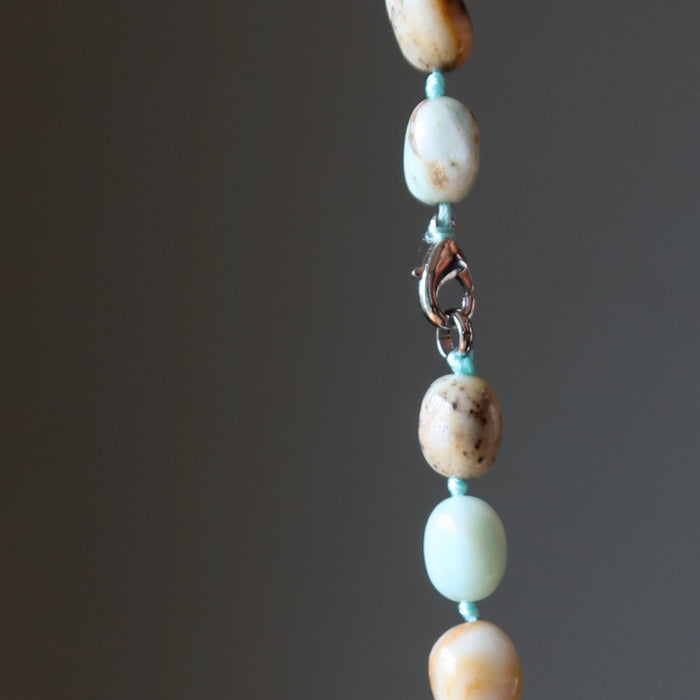 Amazonite Necklace with turquoise and beige beads on a dark background