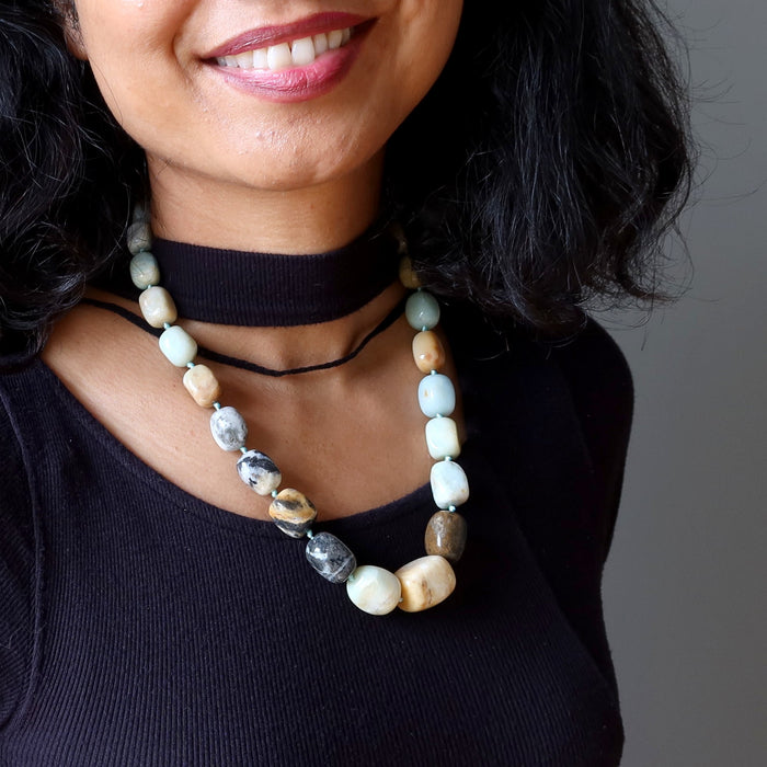 Woman wearing a beaded Amazonite necklace with a neutral background