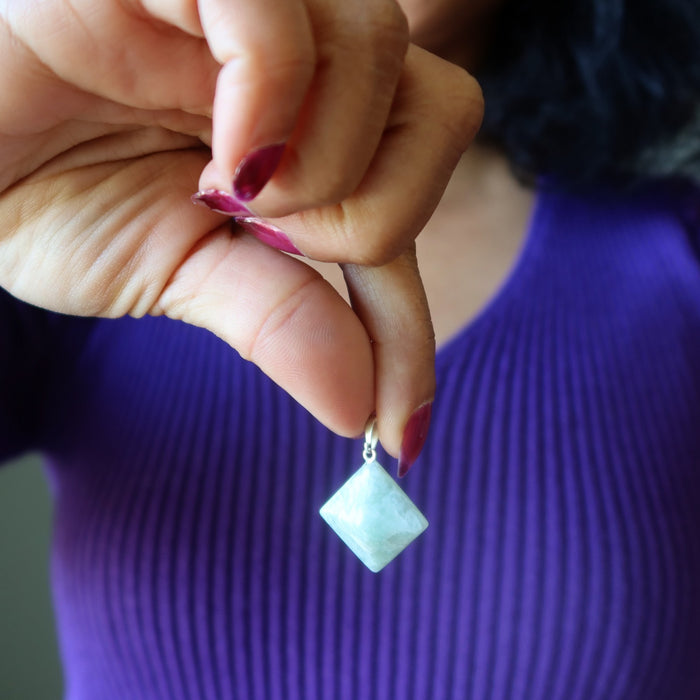 Hand holding a Amazonite pyramid pendan