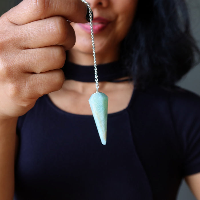 Person holding a green amazonite  pendant necklace