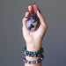 amethyst egg and bracelets in hand