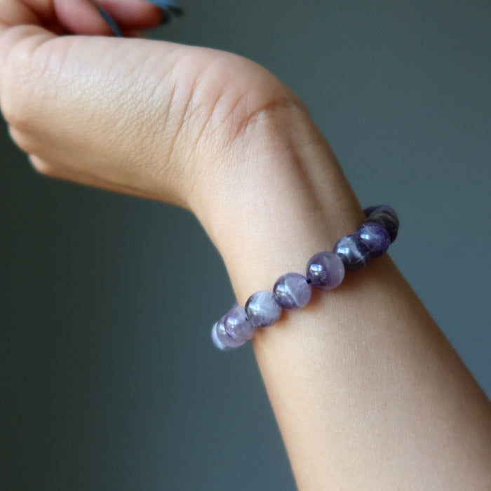 chevron amethyst Purple beaded bracelet on a wrist against a dark background