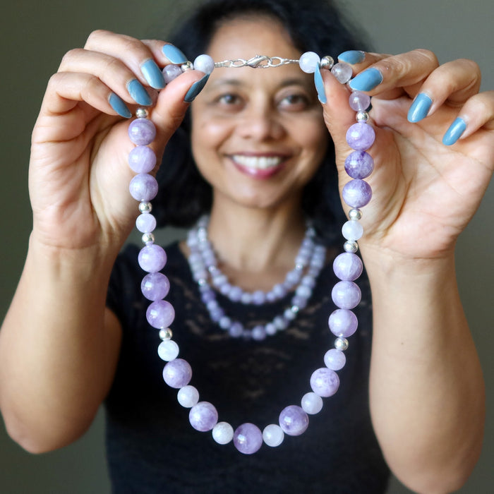 woman holding and wearing Lavender Amethyst necklaces