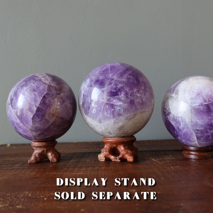 light purple amethyst spheres on display stands
