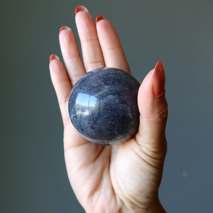 blue aventurine crystal ball in hand