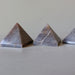 three gray stormy aventurine pyramids