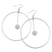 A pair of silver-finished steel hoop earrings with blue calcite gemstones.