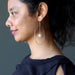woman wearing blue calcite hoop earrings