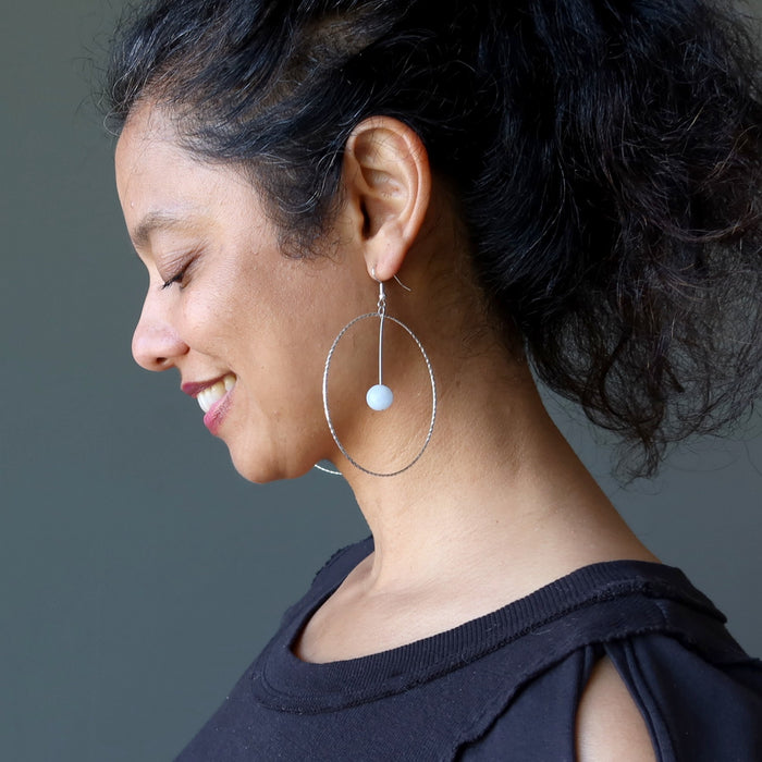 woman wearing blue calcite hoop earrings
