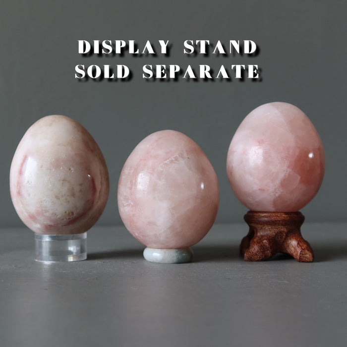 pink calcite eggs on display stands