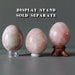 pink calcite eggs on display stands