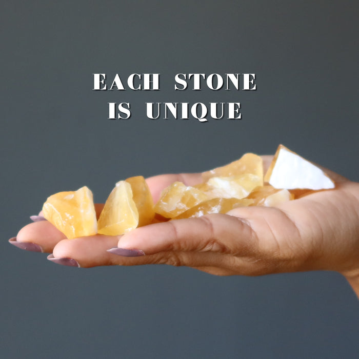 rough yellow calcite stones in hand
