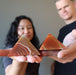 models holding carnelian pyramids