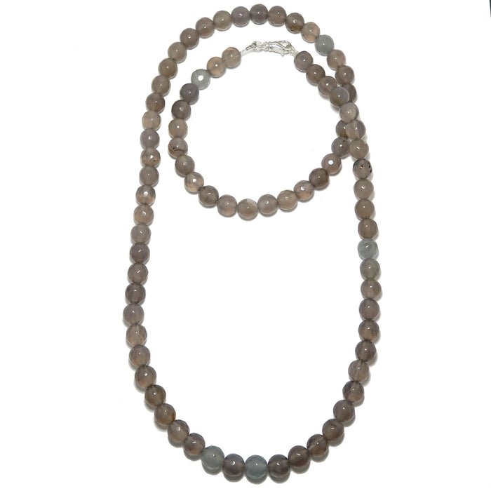 Long necklace with gray chalcedony beads on a white background