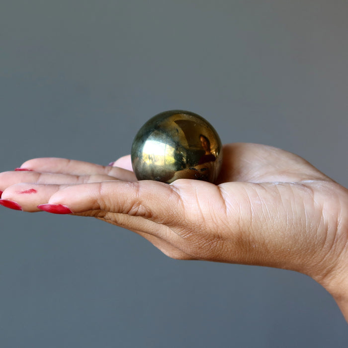 chalcopyrite sphere in hand