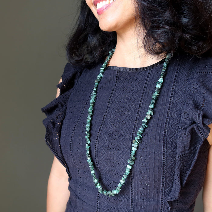 model wearing long emerald necklace