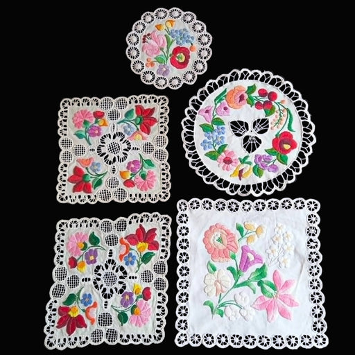 Set of hungarian kalocsa embroidered doilies with floral patterns on a black background