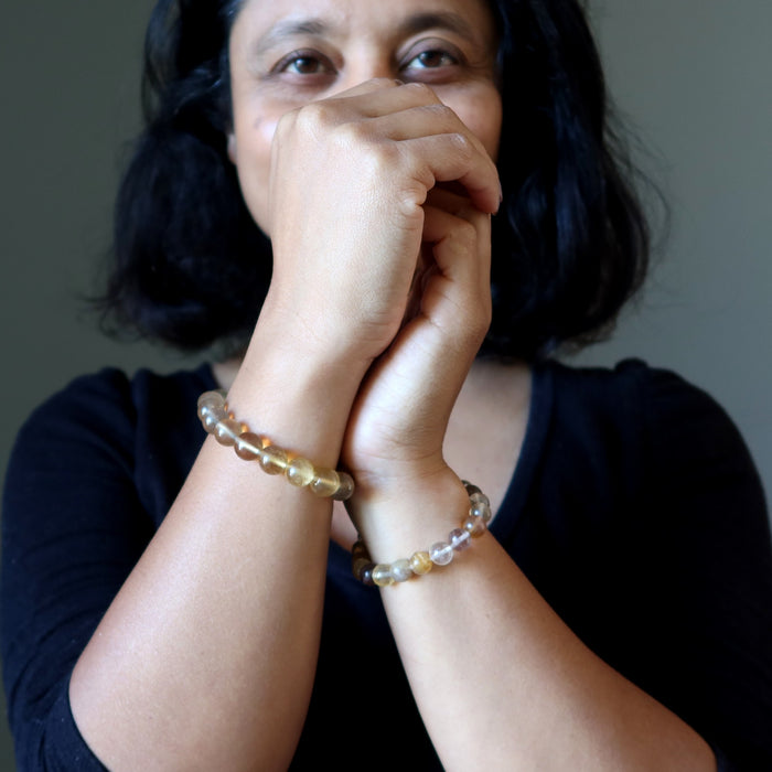 woman wearing golden fluorite bracelets