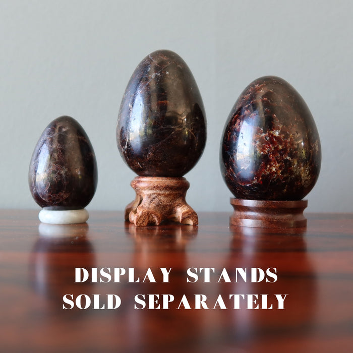 red garnet eggs on display stands