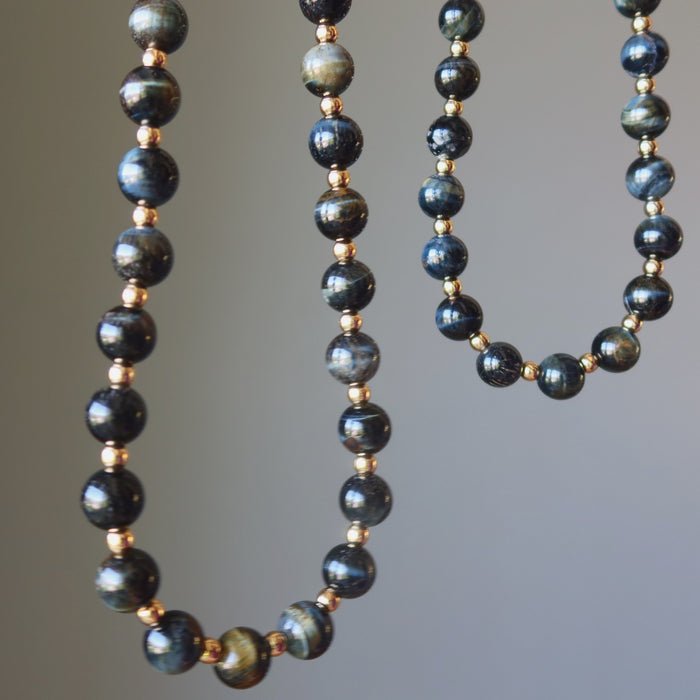 two hawks eye and gold beaded necklaces