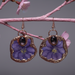 Pair of earrings with purple floral design on a branch with pink flowers.