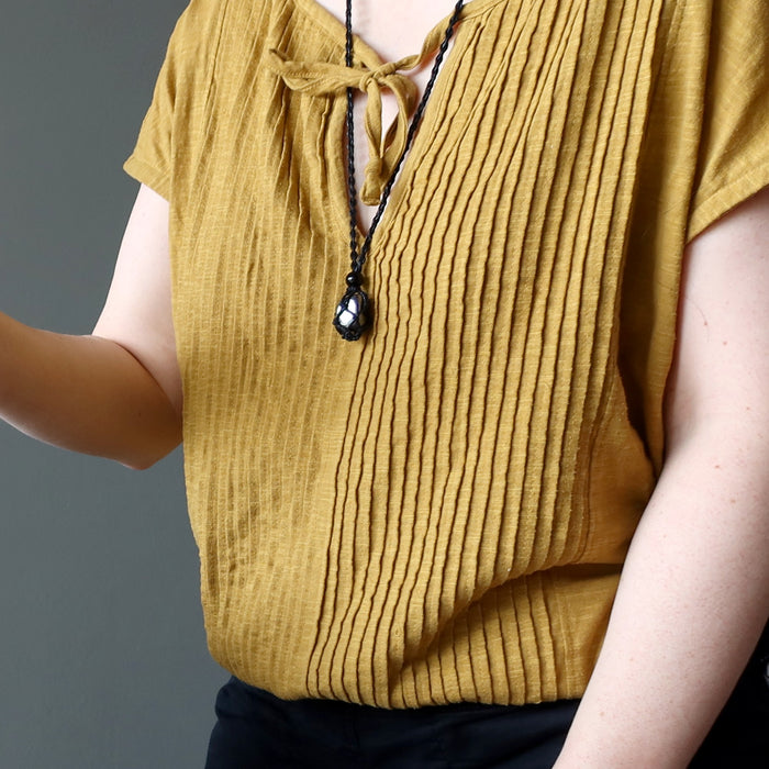woman wearing hematite necklace
