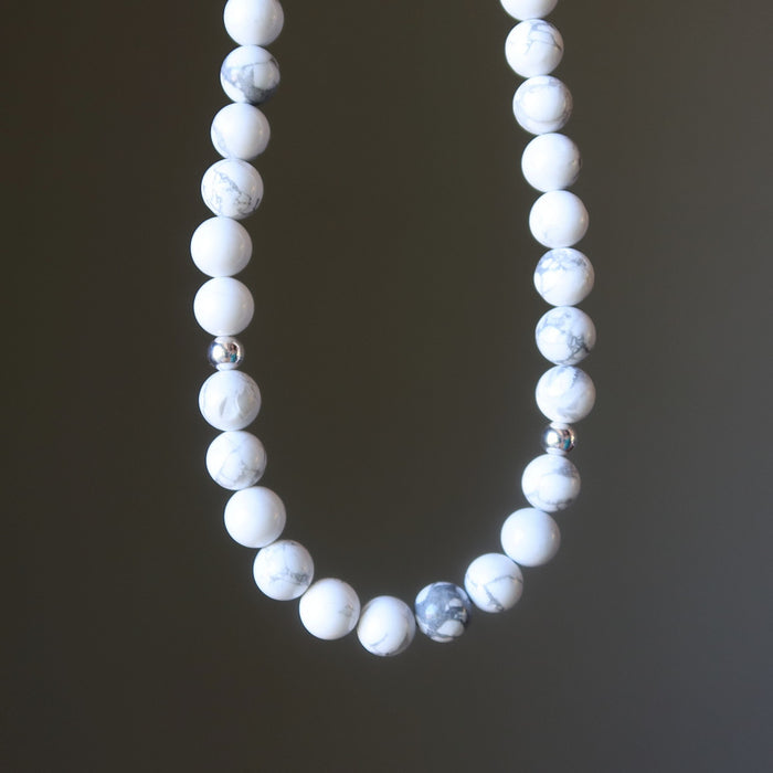 Howlite necklace with white and gray beads on a dark background