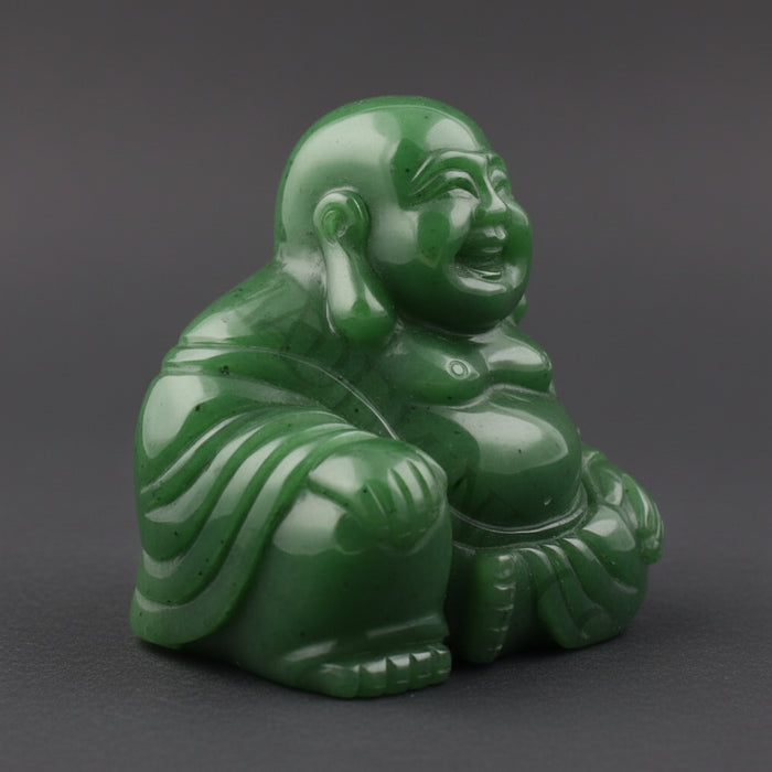 Green jade Buddha figurine on a white background