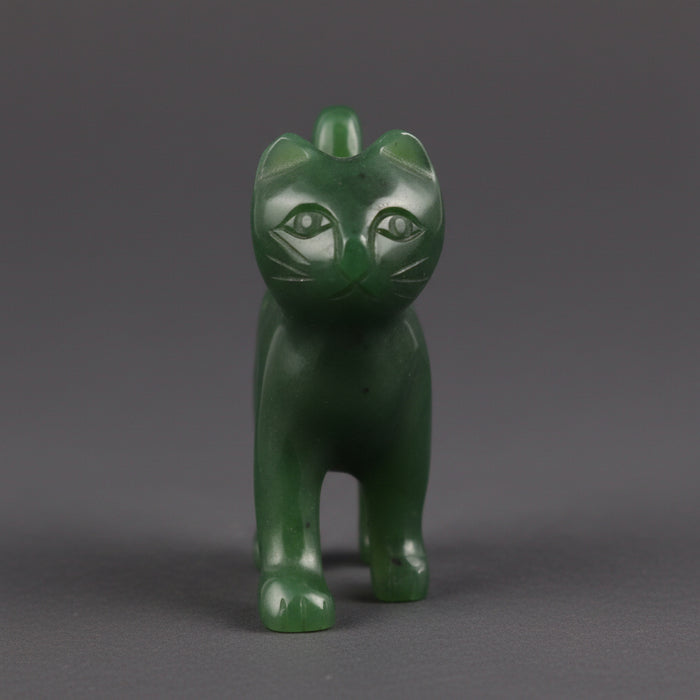 Green jade cat-shaped figurine on a white background