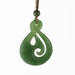 Green jade spiral pendant on a white background