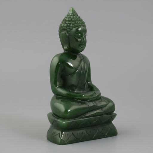 Green Buddha statue on a white background