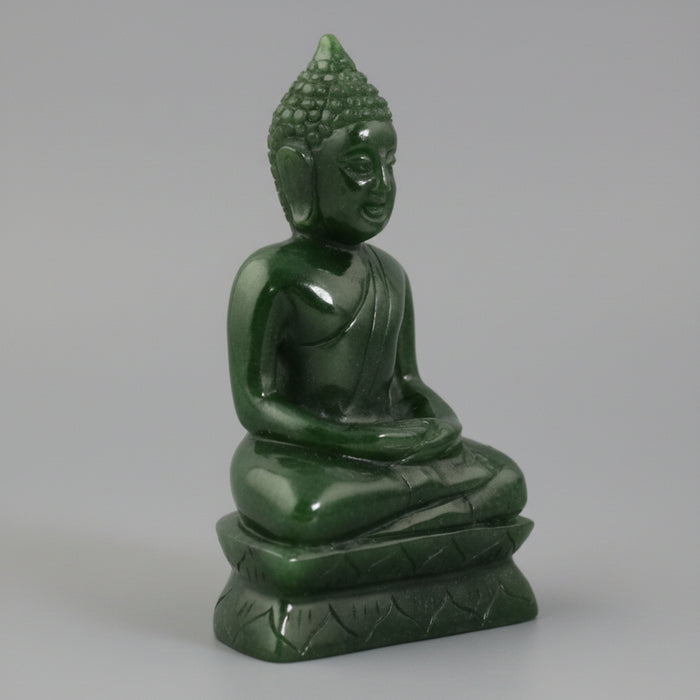 Green Buddha statue on a white background