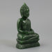 Green Buddha statue on a white background