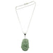 A sterling silver snake chain necklace with a carved green Nephrite Jade pendant in the shape of a horse.