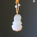 Yellow Jade Kwan Yin Necklace on a dark background