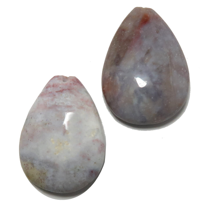 Two teardrop-shaped stones with a marbled pattern on a white background