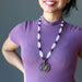sheila of satin crystals wearing Dragon Medallion strung on frosted glass brown jasper and garnet beads necklace