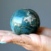 green ocean jasper sphere in hand
