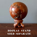red ocean jasper sphere on wood ball stand