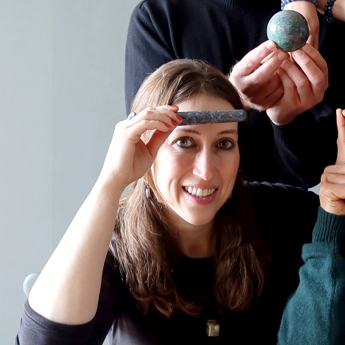 woman with blue kyanite massage wand on forehead