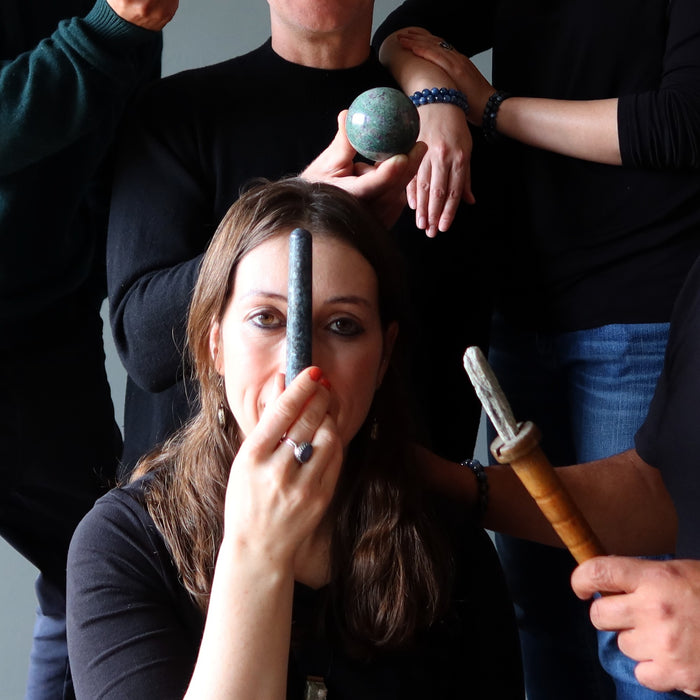 woman with blue kyanite massage wand